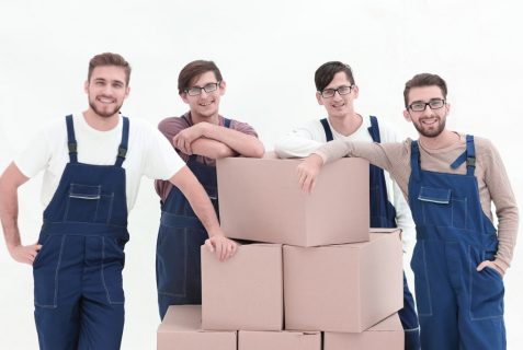 Men holding pile of carton boxes isolated on white background